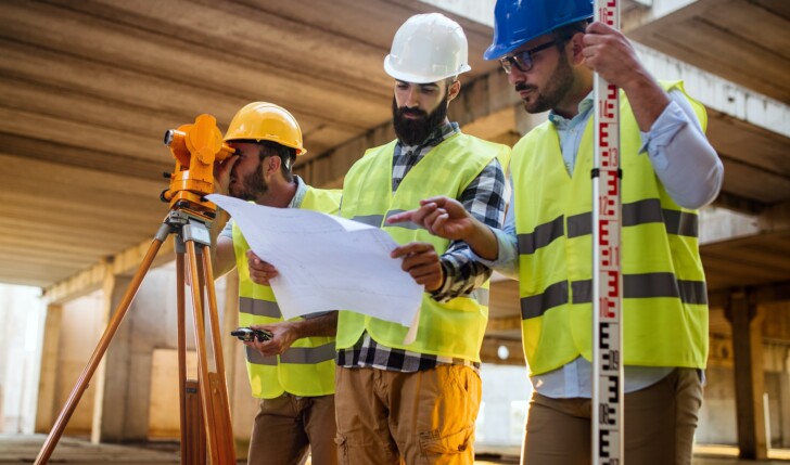 Business building teamwork people concept. Group of engineer with blueprint on construction site